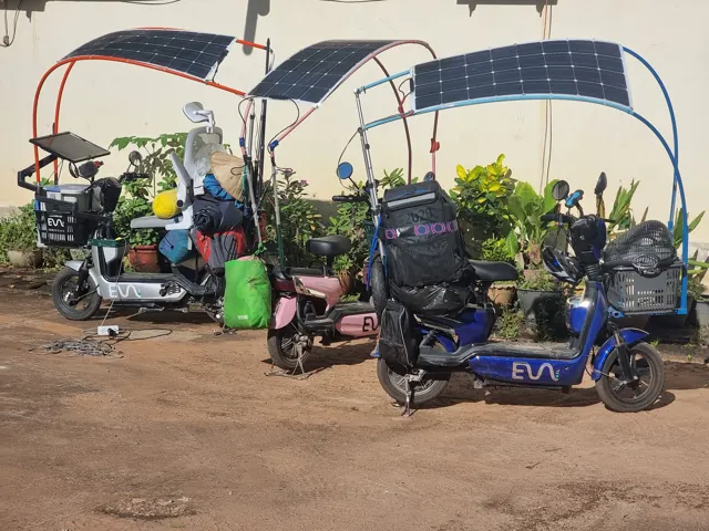 Three e-bikes with curved flexible solar panel roofs